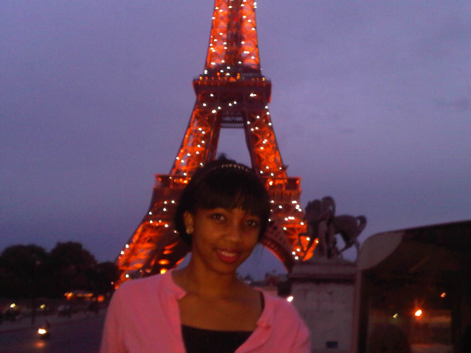 Khadijah on her first solo trip, with the Eiffel Tower behind her.